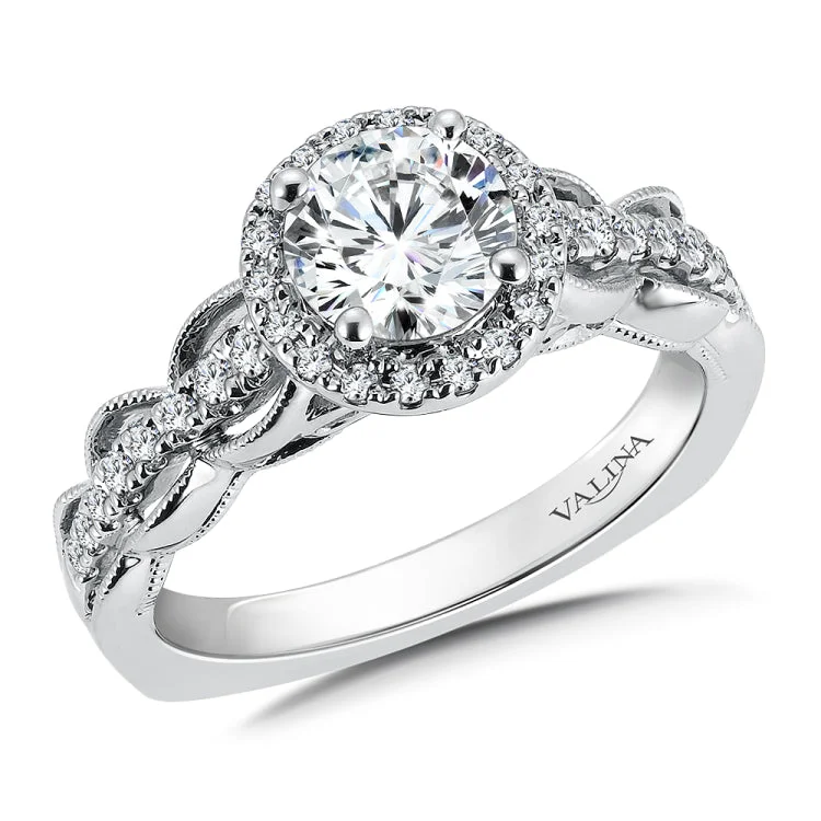 Diamond halo engagement ring mounting with milgrain detailing and side stones set in 14k white gold.